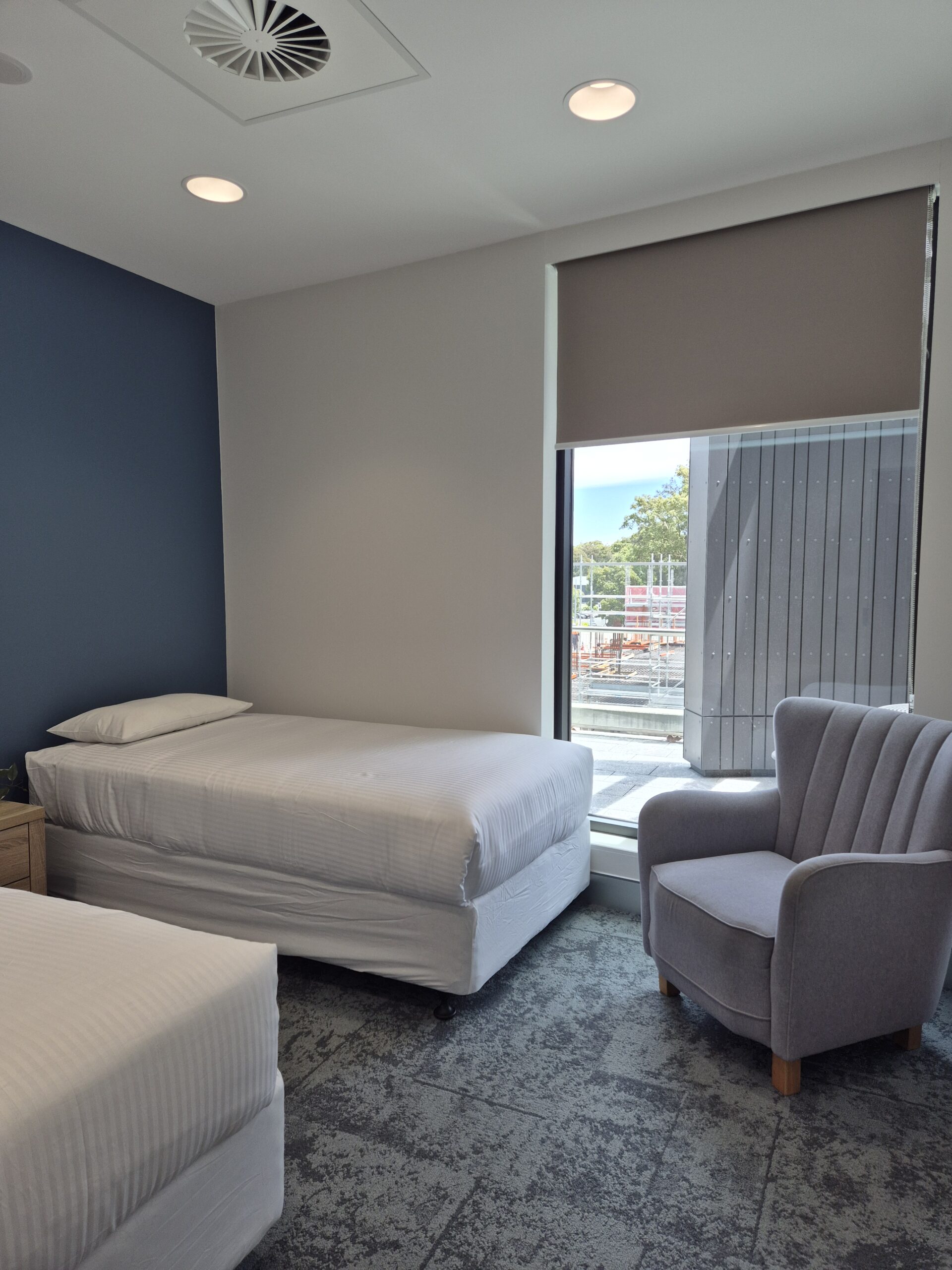 Nap room with two beds and a small desk with chair at the Ronald McDonald House Greater Western Sydney Family Room, The Children's Hospital at Westmead