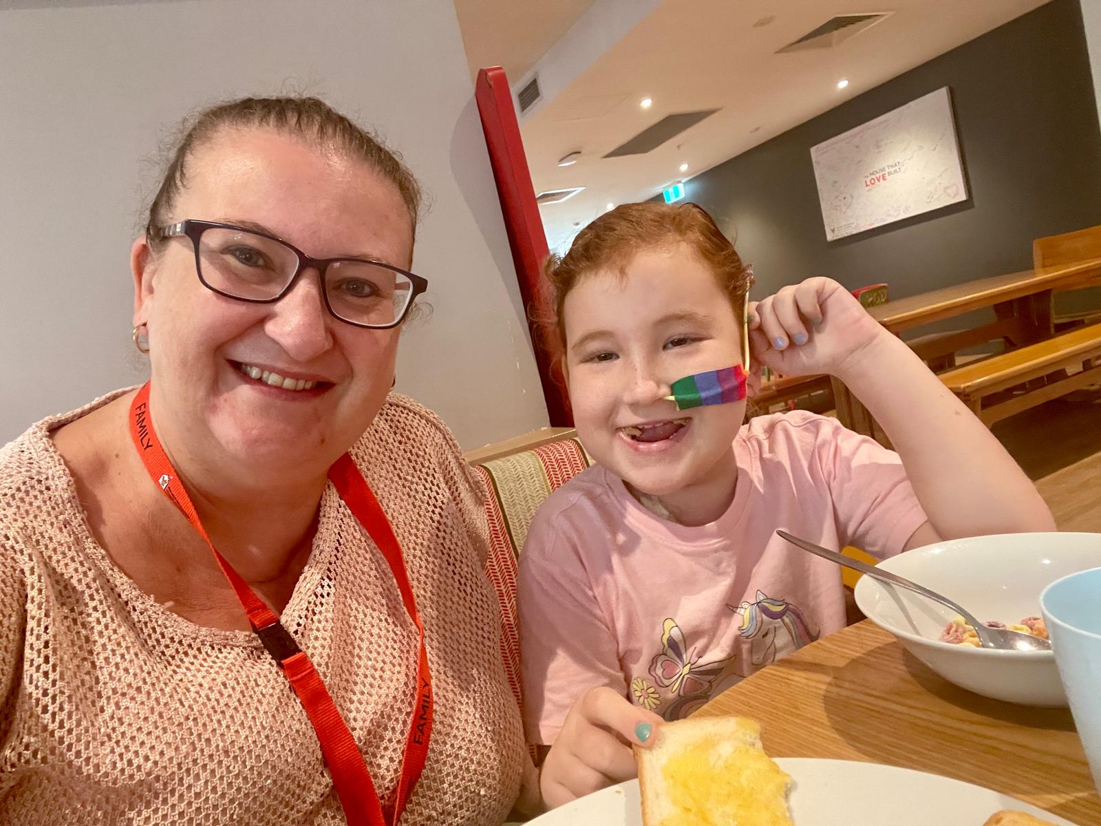 Sick child and her mum having breakfast at Ronald McDonald House Westmead