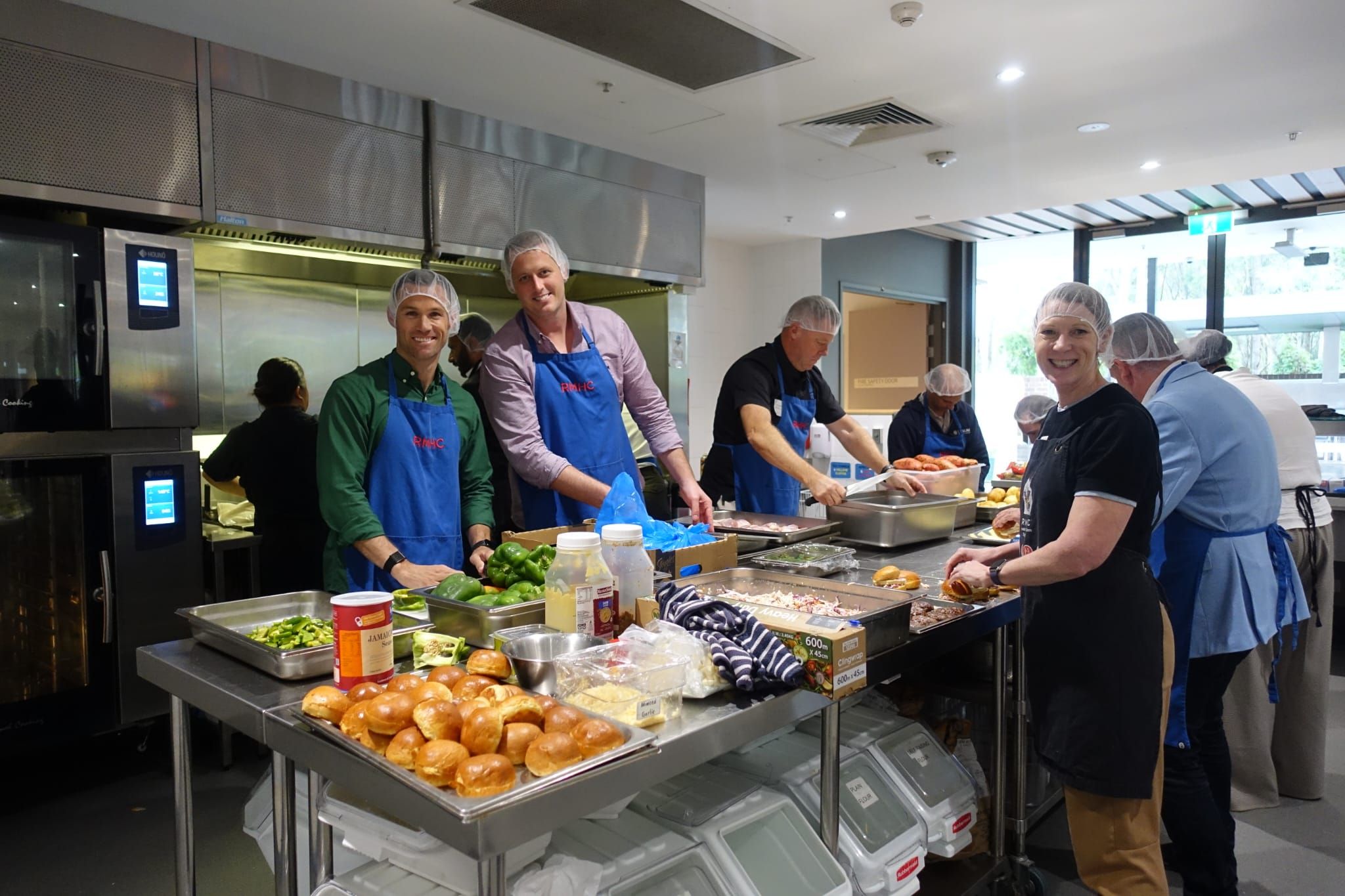 Western Sydney Business Connection in the kitchen at Ronald McDonald House Greater Western Sydney Westmead, preparing ready-made meals for families as part of the Cook + Connect group volunteering program