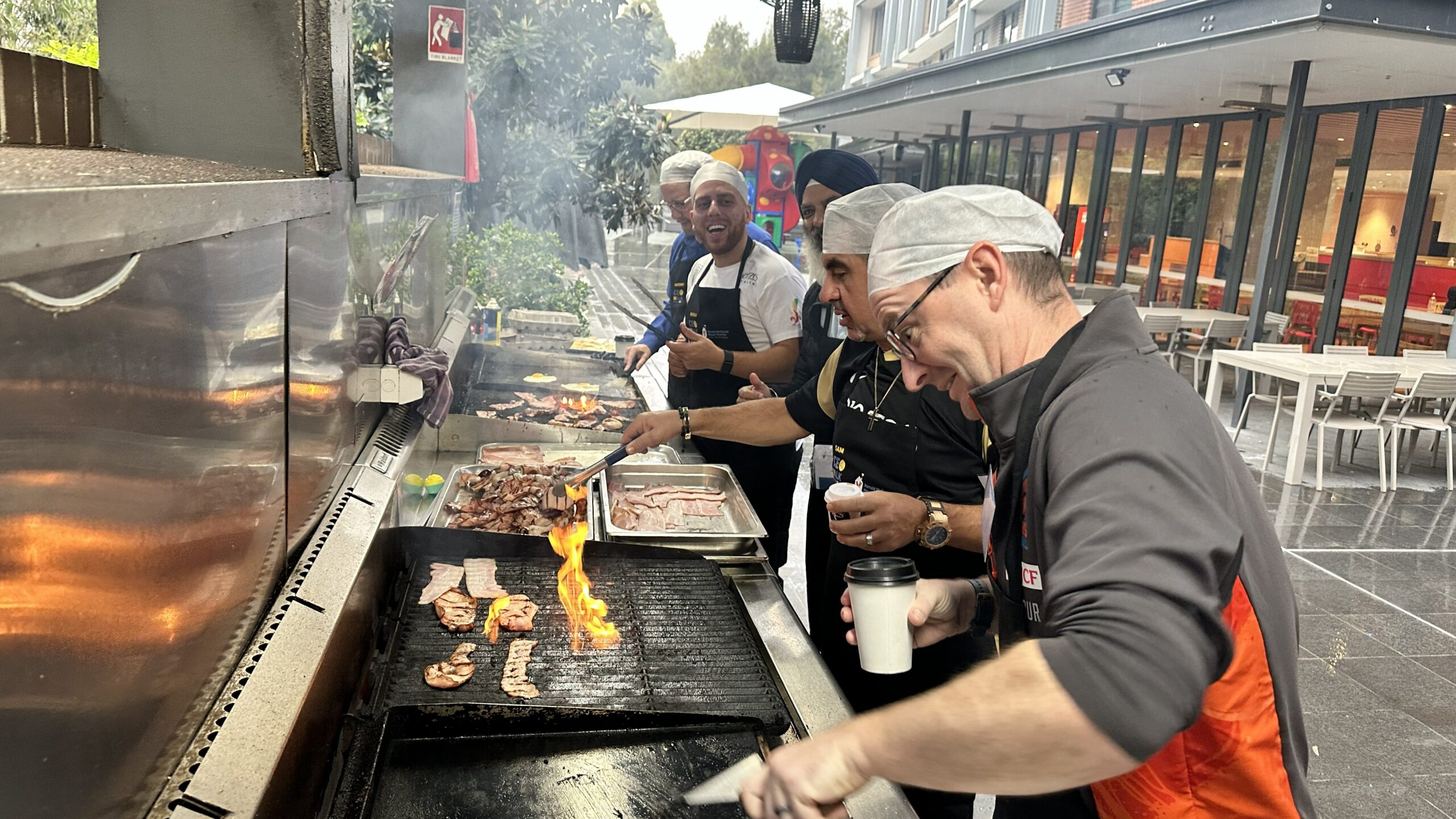 A group of senior leaders and CEOs preparing breakfast for families staying at Ronald McDonald House Greater Western Sydney Westmead as part of the Rise and Dine group volunteering program